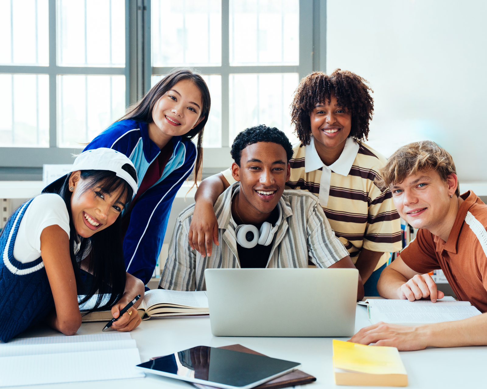 Diverse group of students collaborating with technology